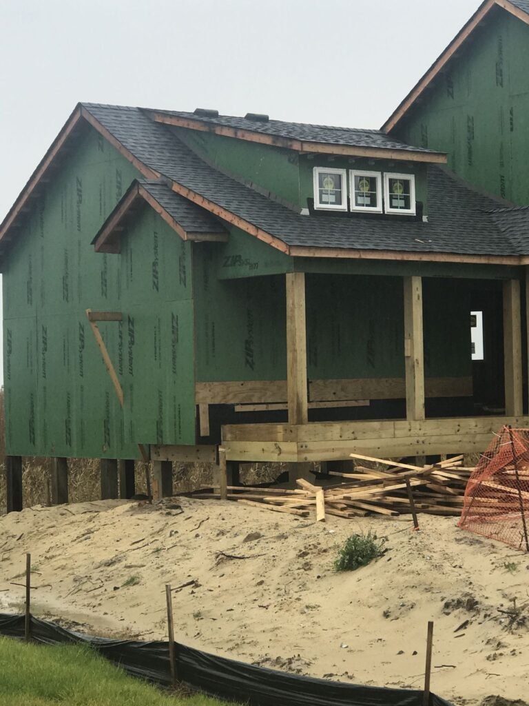 Covered porch framed onto a house by Cas and Cal Construction